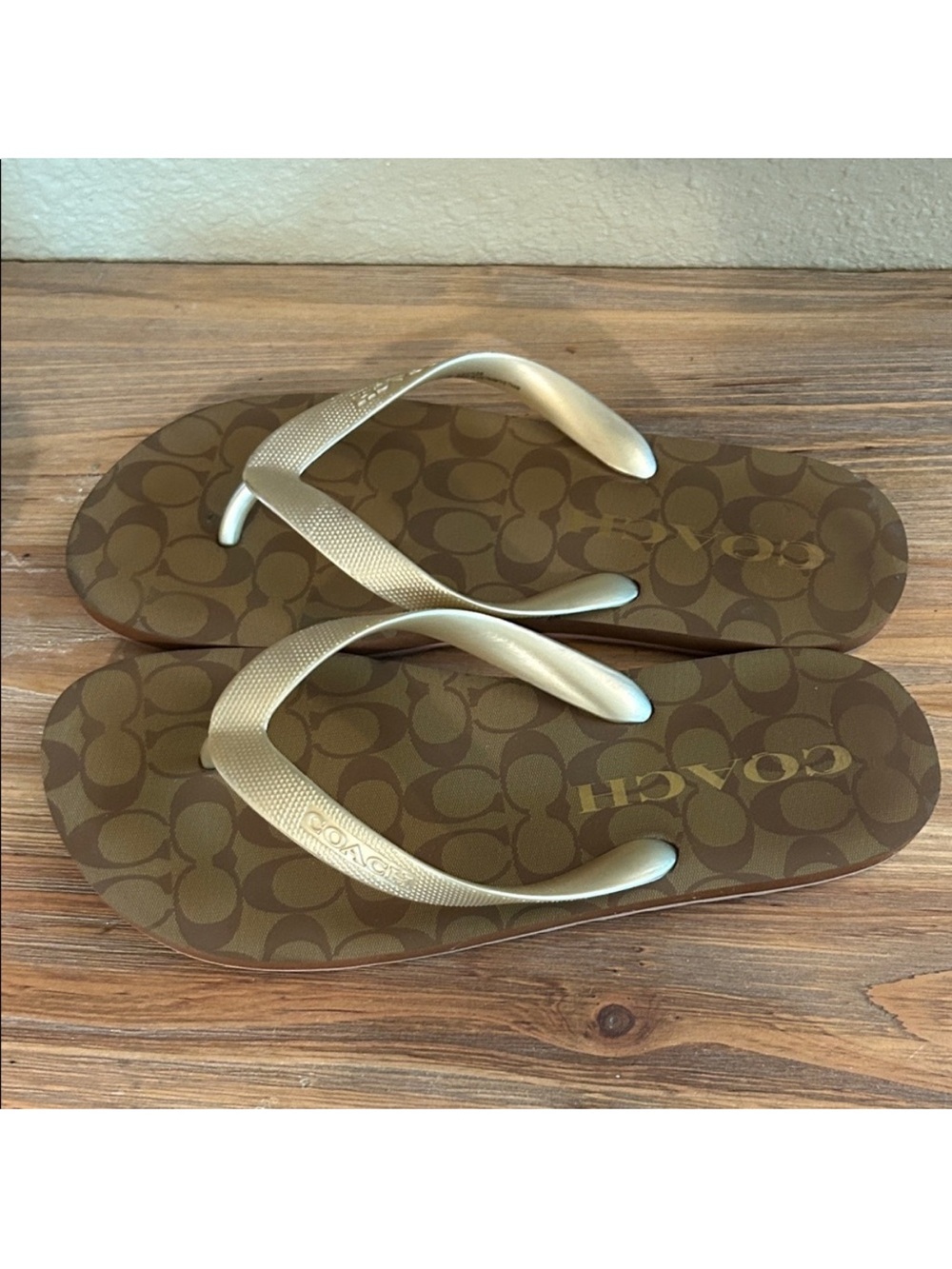 Coach “Zak” Brown Logo Flip Flops in the Khaki/Gold.